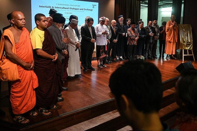 Leaders and representatives of different faiths from Indonesia and Singapore observing a minute of silence yesterday before the launch of the 1st Indonesia- Singapore Interfaith and Intercultural Dialogue and Exchange held in conjunction with the 50t