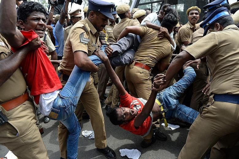 Indian police removing members of the Revolutionary Students and Youth Front during a protest against Prime Minister Narendra Modi and the ban on the sale of cows for slaughter in Chennai on May 31.