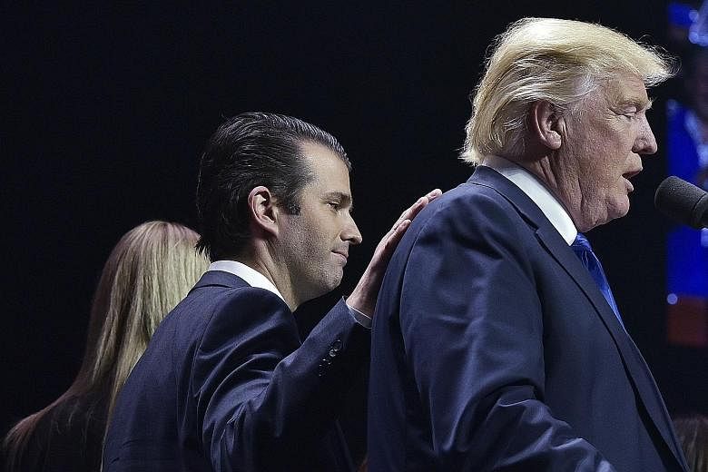 Mr Donald Trump Jr with his father Donald Trump at a rally in November last year. Mr Trump Jr acknowledged that he met a Russian lawyer who promised damaging information about Mrs Hillary Clinton.