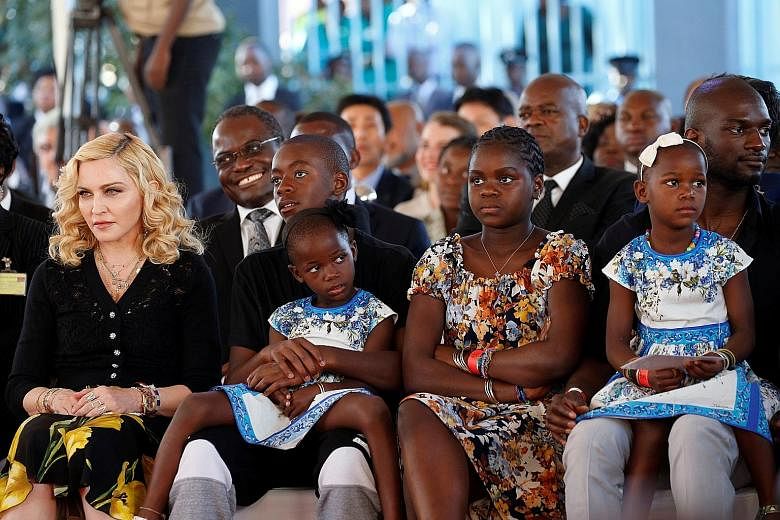 American pop superstar Madonna (left) on Tuesday took her four adopted Malawian children - David Banda and Mercy James, both 11, and twins Esther and Stella Mwale, four - back to their home country for the opening of a children's hospital that her ch