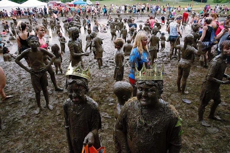 Mackenna Kofahl (left), 12, and Brian Wilson 10, being crowned Mud Day Queen and King as part of the annual Mud Day at Nankin Mills Park in the American state of Michigan on Tuesday. It takes more than 181 tonnes of top soil and 75,700 litres of wate