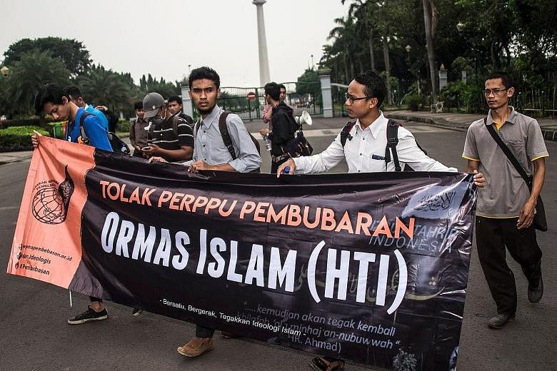 Muslim student activists taking part in an anti-government rally in Jakarta yesterday after Indonesia issued a decree allowing it to ban groups that oppose its official state ideology, Pancasila. Activists said the move is aimed at disbanding Hizb ut
