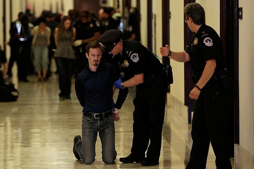 Activists being detained on Monday after a protest against the Republican healthcare Bill at the Senate building in Washington. The week-long congressional recess only seemed to generate more doubts about the Bill.