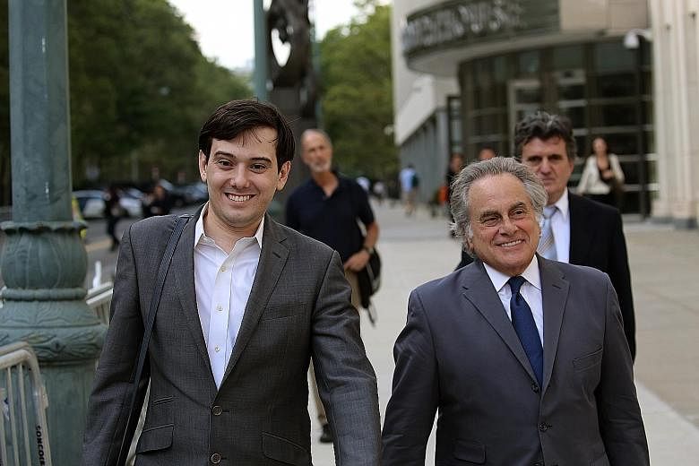 Martin Shkreli (left) leaving the court with his attorney Benjamin Brafman in New York on Monday. Prosecutors say one record showed that Shkreli moved more than US$1.3 million from his start-up drug company, Retrophin, to his personal account.