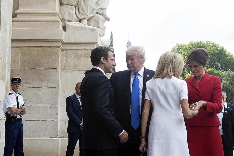 French President Emmanuel Macron (far left) and his wife Brigitte greeting visiting US President Donald Trump and his wife Melania at the Hotel des Invalides in Paris yesterday. Talks between the two leaders would focus on shared diplomatic and milit