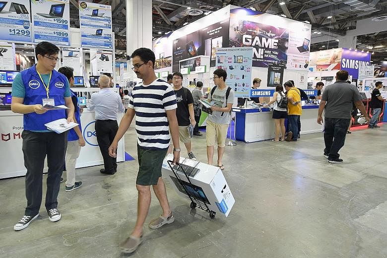 Shoppers checking out The PC Show at the Marina Bay Sands Expo and Convention Centre last month. PC shipments worldwide are down for the 11th quarter in a row, according to Gartner data.