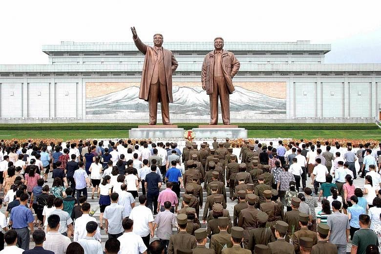 People marking the 23rd anniversary of the demise of North Korea's founding father Kim Il Sung in Pyongyang, in a photo released by North Korea's Korean Central News Agency last Saturday.