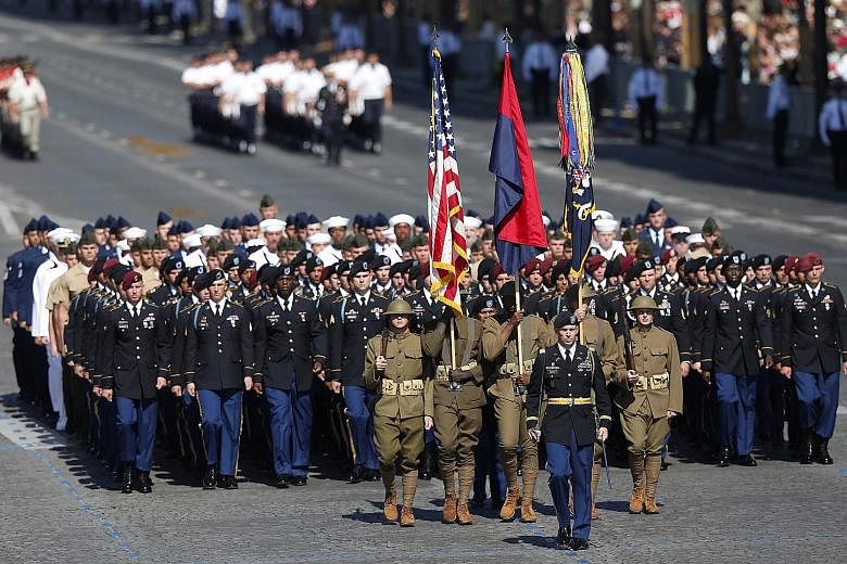 US troops, led by soldiers in US combat attire from World War I, marching in the Bastille Day parade in Paris yesterday. The French government traditionally invites a country of honour to lead the parade, which is linked to a historical event and hig