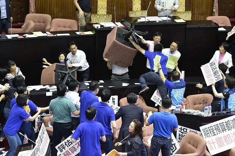 DPP legislators brandishing chairs as opposition MPs called for a boycott of the controversial infrastructure Bill yesterday.