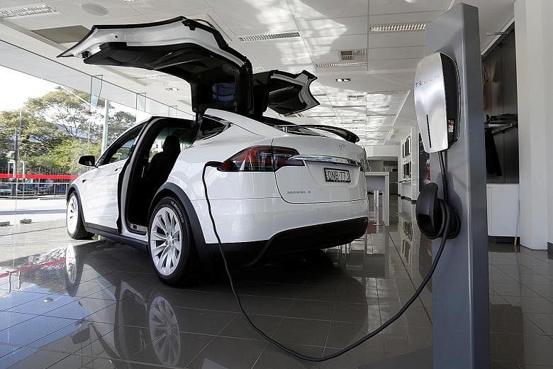 A Tesla wall connector demonstrates the charging at home of a Model X vehicle at a Tesla electric car dealership in Sydney, Australia.