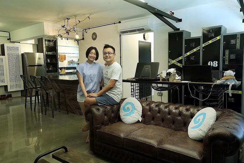 A chesterfield sofa (far left) adds a vintage look to the industrial- themed home of Ms Ng Wan Ting and Mr Desmond Peh (both left). Their bedroom (above) has a similar vibe, with a wardrobe fitted with steel pipes.