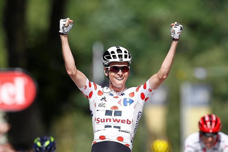 Team Sunweb rider Warren Barguil of France celebrates after winning the 13th stage yesterday.