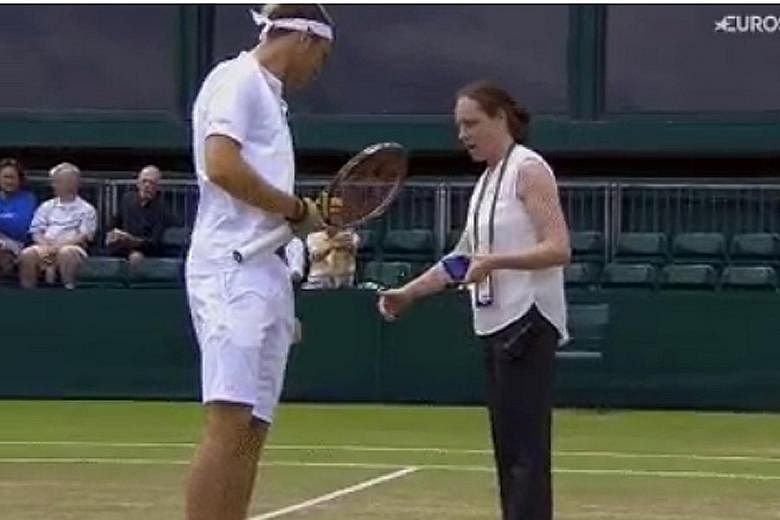 Jurij Rodionov being spoken to by Lucy Grant, a supervisor, who told him that he needed to replace his blue underwear with white, to adhere to Wimbledon's dress code.