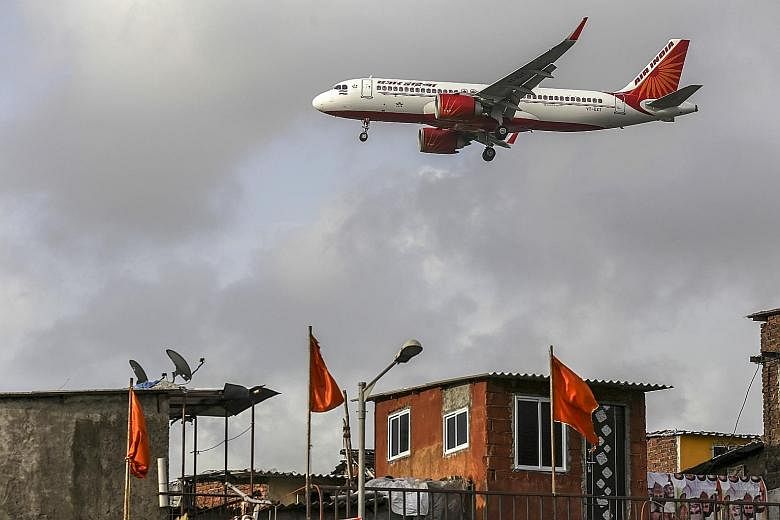 An Air India aircraft landing at Chhatrapati Shivaji International Airport in Mumbai. The Indian Cabinet last month approved the sale of Air India, which has an US$8 billion (S$11 billion debt).