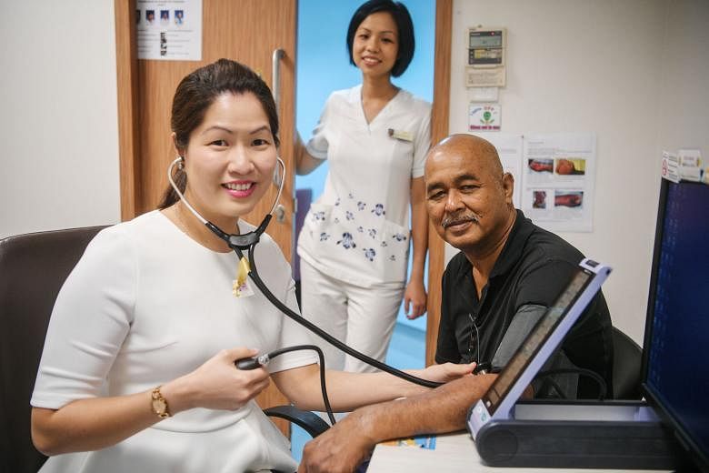 Dr Tricia Chang attending to Mr Adam Salim at Ang Mo Kio Polyclinic, with Senior Staff Nurse Evonne Oh looking on. Dr Chang said patients are more motivated and willing to take charge of their health.