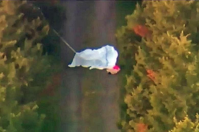 A screenshot from a video of one of the victims on the ground. Footage taken above the driveway showed the parachutes, and indicated that they opened either partially or in full. A Sydney Skydivers plane typically used to fly skydivers. A skydiver wh