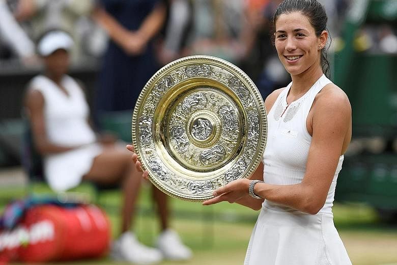 Left: Spain's Garbine Muguruza showing off the Venus Rosewater Dish after beating five-time Wimbledon champion Venus Williams. Below: A nervous Venus Williams endured the disappointment of losing a second Grand Slam final this season.