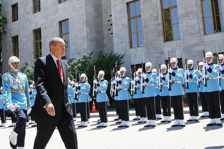 Turkish President Recep Tayyip Erdogan reviewing the guard of honour on his arrival in Ankara yesterday for a special session of Parliament, to mark the first anniversary of the failed attempt to overthrow him. Just hours before the commemorations we