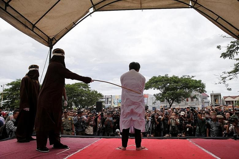 An Indonesian man being publicly caned in Banda Aceh, the capital of Aceh province, on May 23 for having gay sex. The conservative Indonesian province currently holds canings in front of mosques, right after Friday prayers, and huge crowds gather to 
