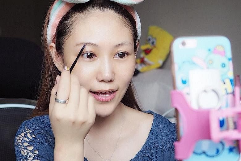 Above: Online host Zhang Xiaoxi starts her day every day in front of her mobile phone talking to hundreds of online viewers, including taking them through her daily routine of putting on make-up. The former model has been doing this full-time for nea