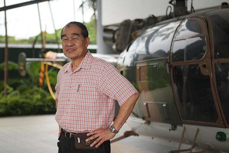 Above: The state flag is flown by a Chinook helicopter and its Apache escorts over the anchorage to the south of the Singapore mainland. Left: Lieutenant- Colonel (Ret) Leo Tin Boon, a former pilot, beside an Alouette III helicopter at the Air Force 