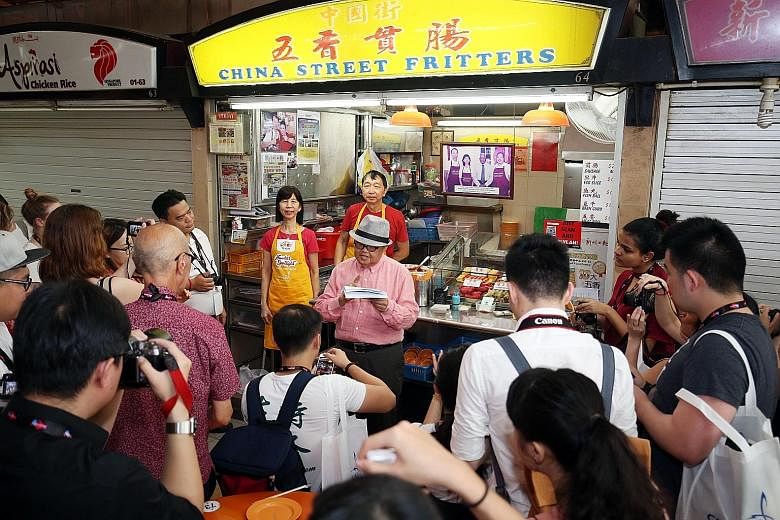 Celebrity Moses Lim telling the media about the signature dishes that China Street Fritters offers, with stall co-owners Ng Kok Hua - who is Mr Richard Ng's brother - and his wife Ong Siew Eng in the background. Left: Roasted pork, char siew and roas