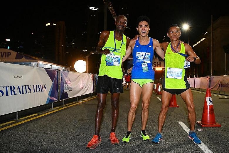 The top three male runners in the ST Run's signature 18.45km race are (from left) Kenyan James Karanga, the winner; Singaporean Mok Ying Ren, who took third place; and Nepali Nimesh Gurung, who was second.