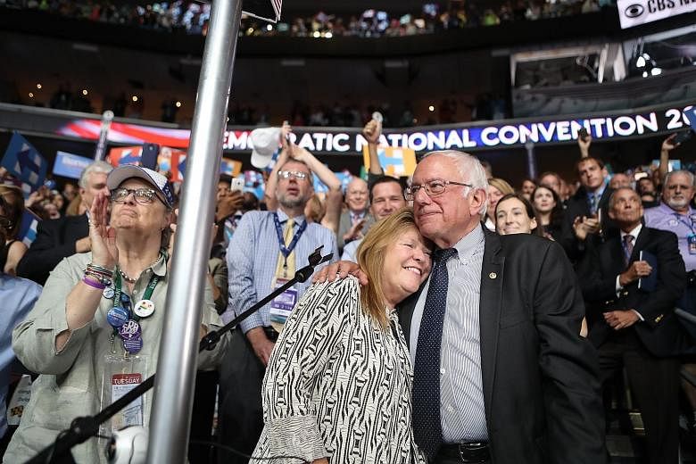 Senator Bernie Sanders and his wife, Jane, at last year's Democratic National Convention. Though Mr Sanders is still riding high on popularity from his presidential bid, he has been shadowed by talk of a federal probe into his wife's role in a 2010 l