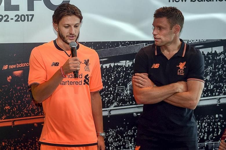 Adam Lallana sporting Liverpool's new third kit alongside vice-captain James Milner in Hong Kong. The Reds will play Crystal Palace tomorrow.