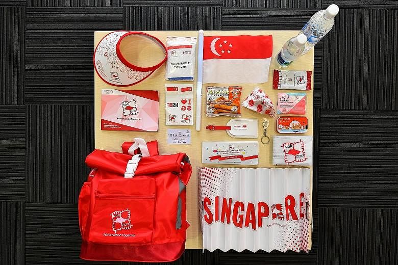 Left: Lasalle College of the Arts graduate Riche Tay and coursemate Denise Richter spent about a month designing the funpacks. Above: Some of the items inside include a mini Singapore flag, which doubles as a flashing LED light, and a handy paper ban