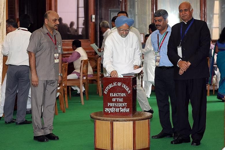 Former Indian prime minister Manmohan Singh casting his vote at Parliament House in New Delhi yesterday to elect the country's 14th president, a largely ceremonial post that is being contested by ruling BJP candidate Ram Nath Kovind and opposition Co