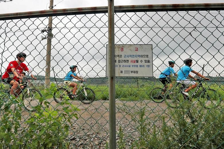 People cycling yesterday near Paju, north of Seoul, along the demilitarised zone separating the two Koreas, at an event to promote inter-Korea peace. Seoul has proposed a meeting to be held on Friday.