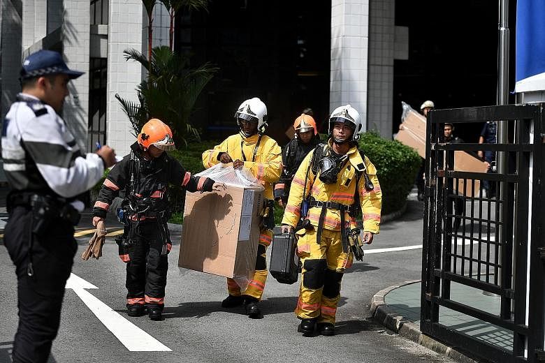Above: SCDF and HazMat officers at the scene of the incident. At about 3.50pm yesterday, the SCDF said its HazMat detectors showed no reading of the chemical vapour in the production room. The surrounding environment was also declared safe, with no t