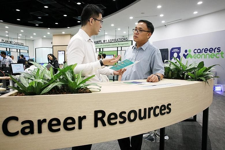 Mr Chong Choon Yew (right) with career coach Andrew Er at Workforce Singapore's Careers Connect centre at the Lifelong Learning Institute in Paya Lebar. After 20 years as a product engineer, Mr Chong made the switch to become a care coordinator at th