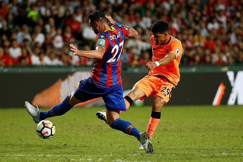 Crystal Palace defender Damien Delaney is unable to stop Liverpool's new striker Dominic Solanke from scoring the opening goal in Hong Kong yesterday. The Reds won the Premier League Asia Trophy match 2-0.
