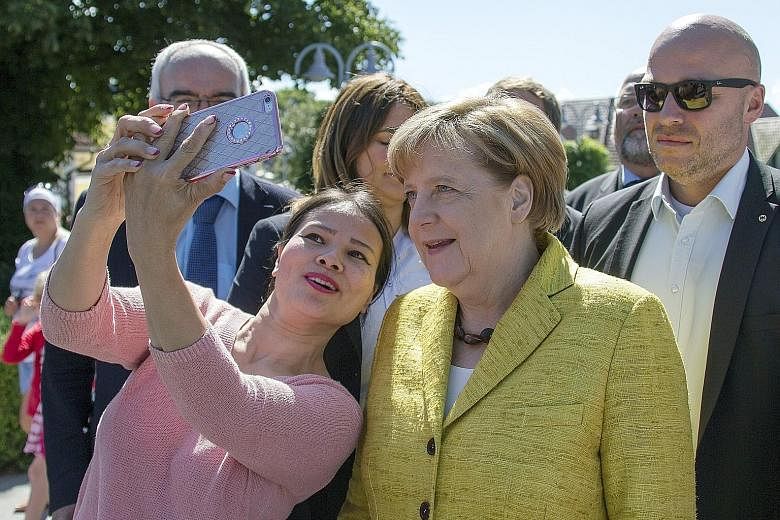 German Chancellor Angela Merkel during her summer tour in Zingst, Germany. Dr Merkel has come under attack at home and abroad over the European powerhouse's balance sheets ahead of her country's general elections. But Germans support her government's