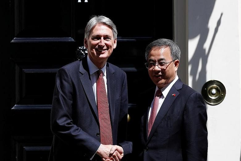 British Chancellor of the Exchequer Philip Hammond with Mr Hu Chunhua outside 11 Downing Street in London during the Guangdong party chief's visit to Britain last month. Such trips are often used by senior Chinese officials to burnish their internati