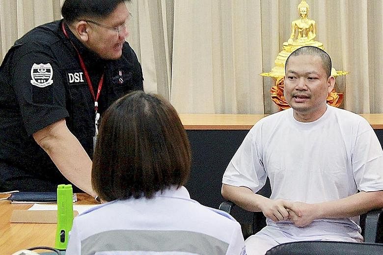Former Thai monk Wiraphon Sukphon being questioned by the authorities in Bangkok on Wednesday.