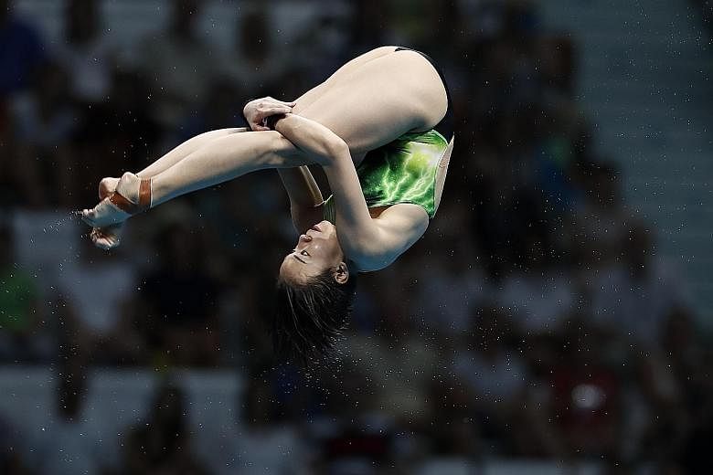 From top: Cheong Jun Hoong of Malaysia on her way to the gold medal in the women's 10m platform event at the World Aquatics Championships in Budapest, Hungary. Cheong is overcome by emotion after her victory. Initially, she had hoped to "maybe" finis