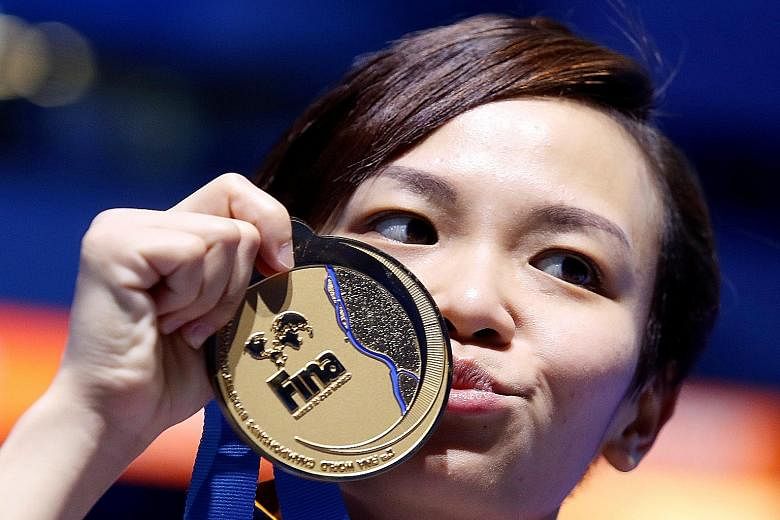 From top: Cheong Jun Hoong of Malaysia on her way to the gold medal in the women's 10m platform event at the World Aquatics Championships in Budapest, Hungary. Cheong is overcome by emotion after her victory. Initially, she had hoped to "maybe" finis