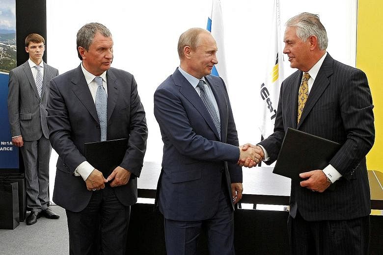 (From left) Rosneft head Igor Sechin, Russia President Vladimir Putin and former ExxonMobil chief executive Rex Tillerson at a signing ceremony at a Rosneft refinery in the Black Sea town of Tuapse, Russia, on June 15, 2012. Mr Tillerson, who is the 