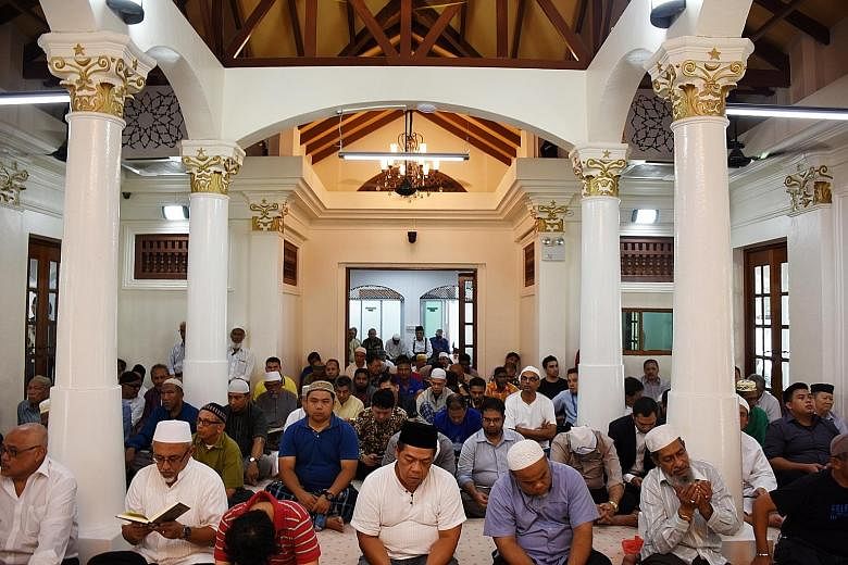 Congregants at the first Friday prayer session at Haji Muhammad Salleh Mosque's prayer hall (top), which is now air-conditioned. The stairs (above) leading to the Habib Noh shrine were also retiled.
