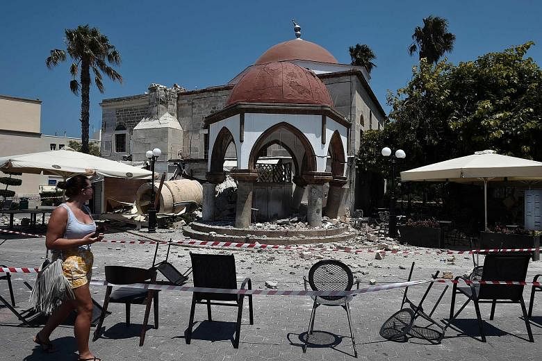 Above: A car in Mugla, Bodrum province, lies damaged yesterday after a small tsunami swept the Turkish shore. Right: