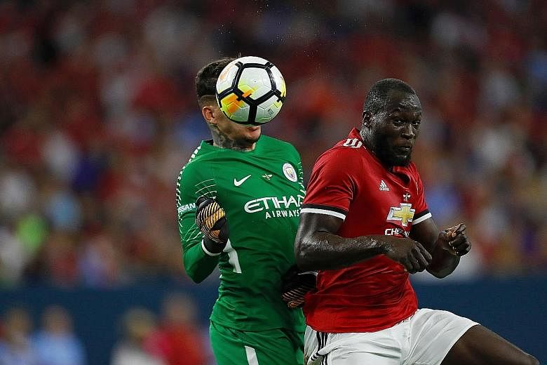 Manchester United striker Romelu Lukaku hitting a header past Manchester City goalkeeper Ederson before scoring during the International Champions Cup match in Houston, Texas. United won the game 2-0.