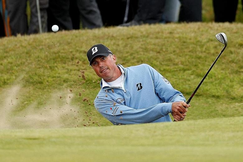 American Matt Kuchar playing out of a bunker on the 15th hole during the second round. He was looking forward to relaxing in his hotel room and watching his rivals on TV as they struggled through even tougher conditions.