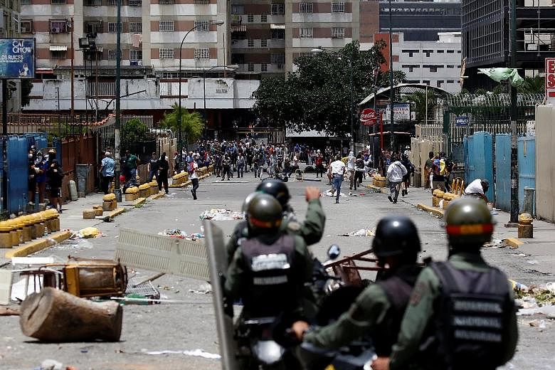 Demonstrators clashing with riot security forces while participating in a strike on Thursday in Caracas, Venezuela.