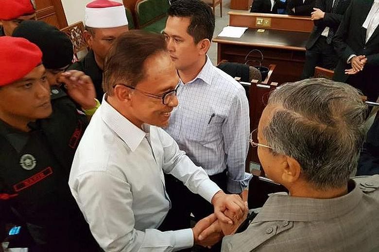 Dr Mahathir Mohamad (right) greeting Anwar Ibrahim in the Kuala Lumpur High Court on Sept 5 last year. The former Malaysian premier said both he and Anwar are "not angry over the past".
