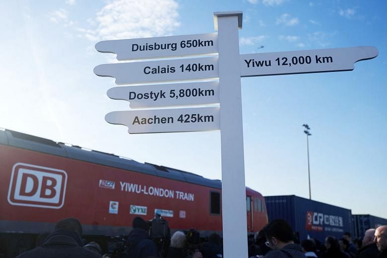 A sign showing the distance to various destinations as a freight train from China arrives at a rail freight depot in east London. The journey started in Yiwu in the eastern Chinese province of Zhejiang and is the latest effort in China's drive to str