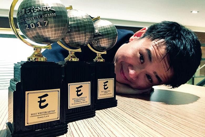 Graphic novelist Sonny Liew with the three Eisner awards he won for his graphic novel, The Art Of Charlie Chan Hock Chye, which retells Singapore's journey to nationhood.
