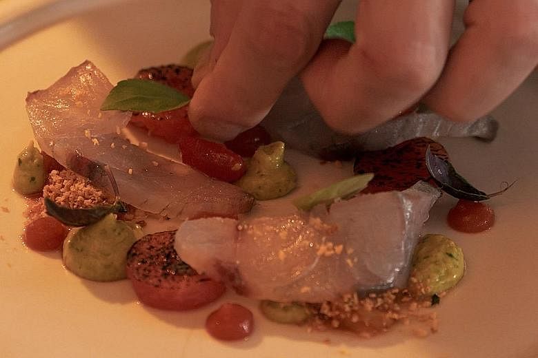 Watch a video which shows barramundi being prepared at a restaurant kitchen (left: cured barramundi, watermelon with tomato vinaigrette and avocado from Pollen).